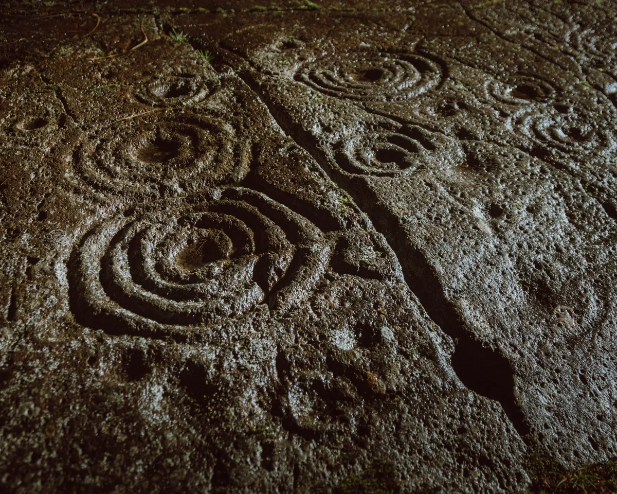 Cup and ring markings carved into rock outcrops at Kilmartin Glen.