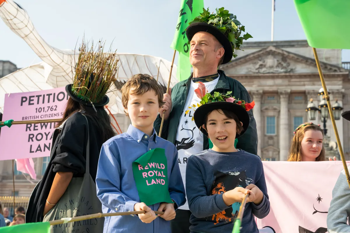CHris Packham stands with a group of young people