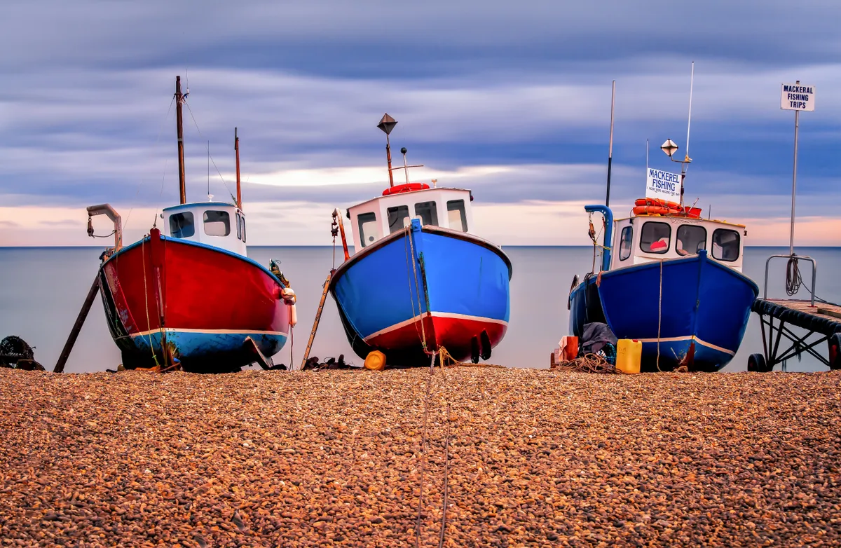 Three fishing boats on the beach at Beer in Devon