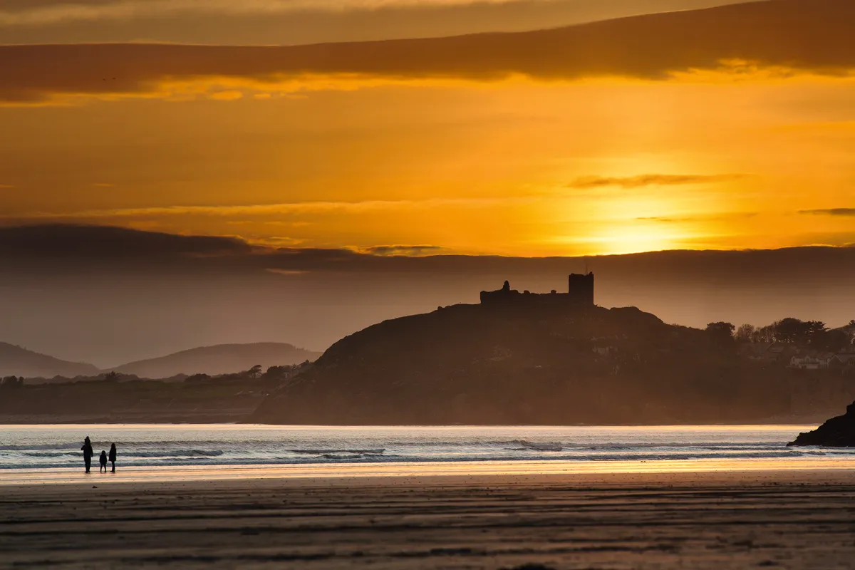Castle on coast with sunset