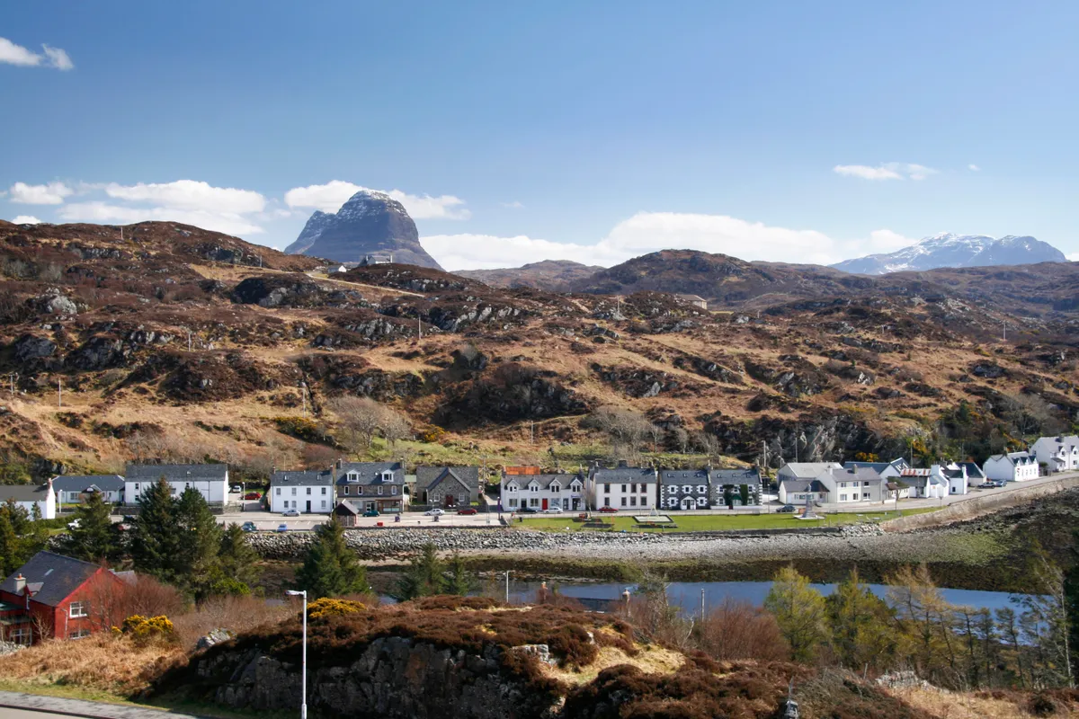 Scottish village of Lochinver on a sunny spring day with Suilven behind