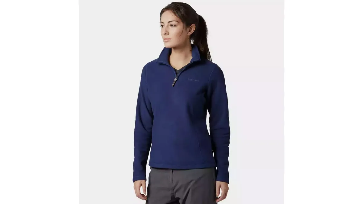 Woman on grey background wearing Women’s Blue Brasher Bleaberry Half Zip Fleece