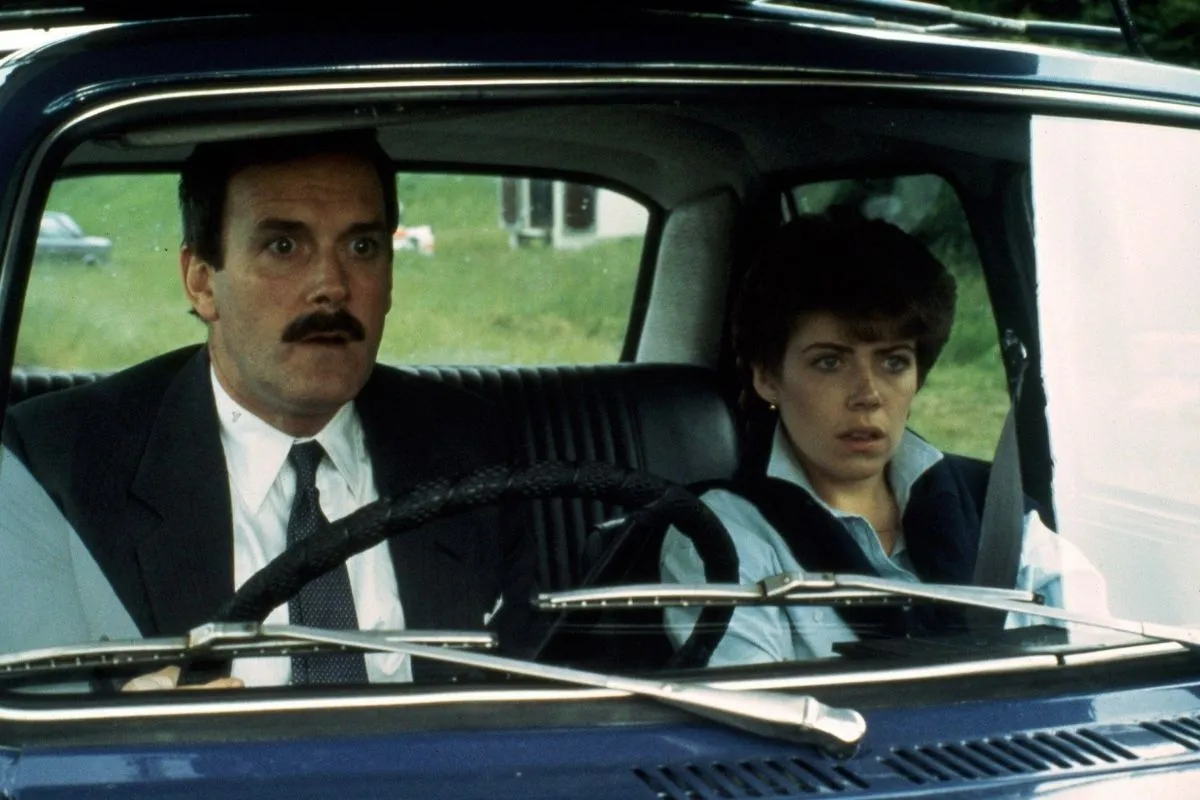 John Cleese and Sharon Maiden in a car
