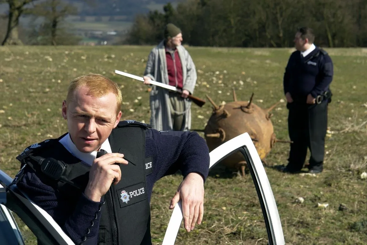 Simon Pegg and Nick Frost as policemen, and , David Bradley as a farmer,in a field