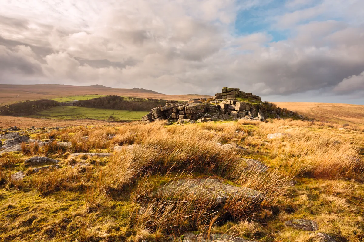 Storm clouds at Winter Tor with views towards Yes Tor, Dartmoor National Park
