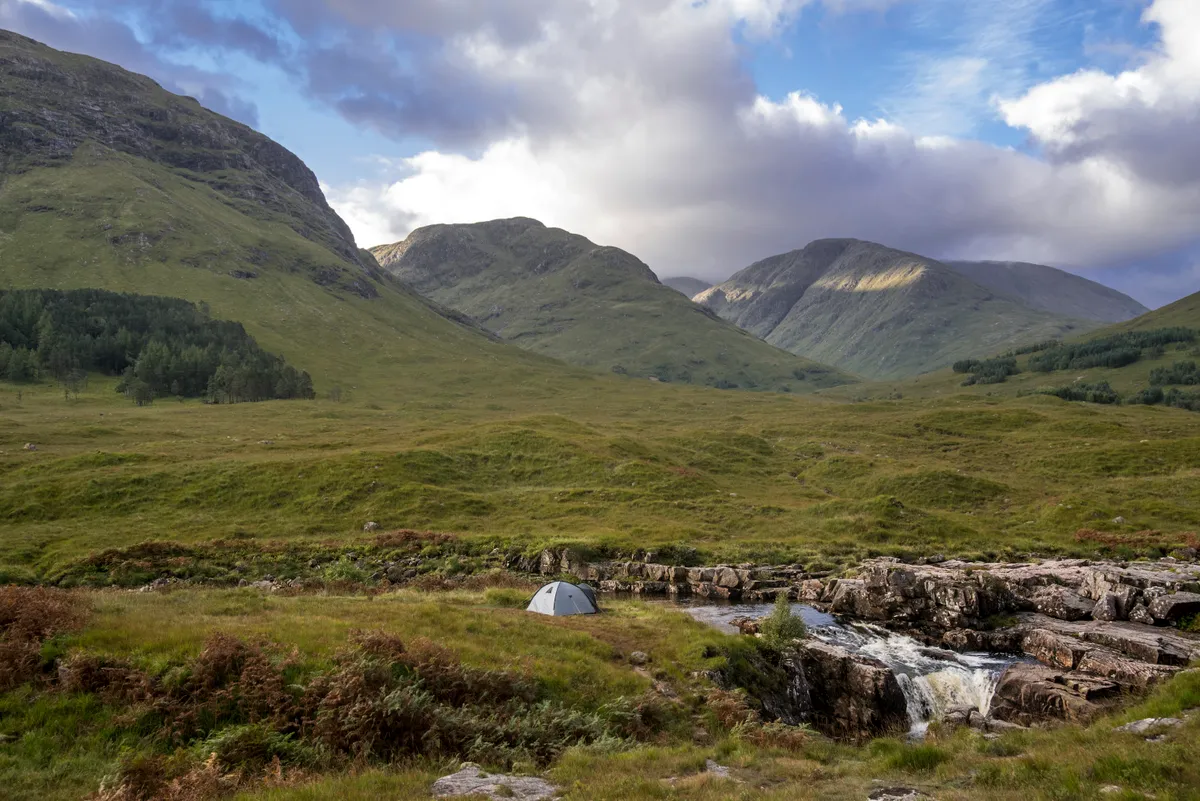 Wild camping with lightweight dome tent along the River Etive.