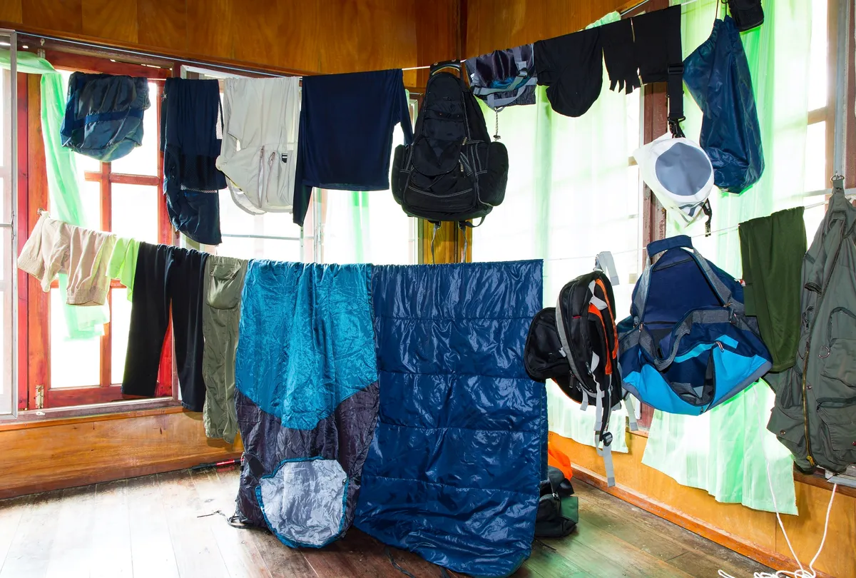 Wet cloths and camping equipments on the rope in house