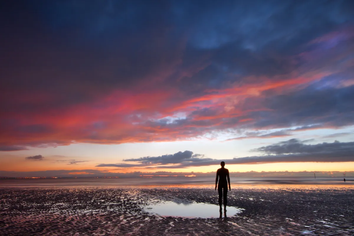 A lone figure on Crosby beach in Liverpool