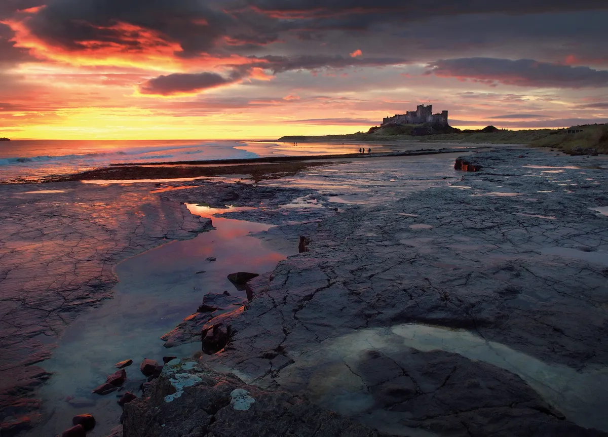 Image of Bamburgh Castle at sunset that appeared as the March photograph for BBC Countryfile Calendar 2023