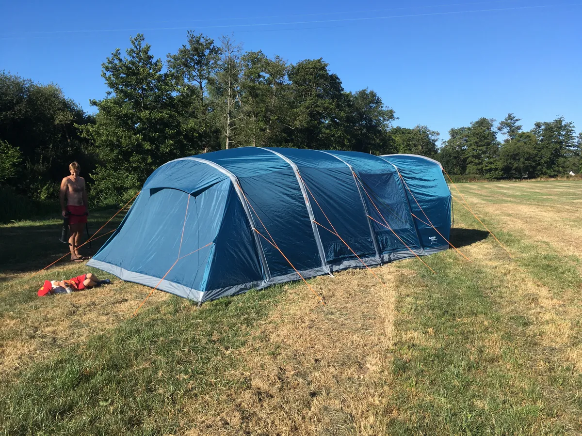Blue Vango Aether air tent in field viewed from the back
