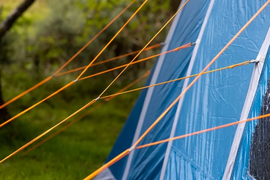 Close-up of the bright orange guy ropes on a Vango Aether Air 600XL tent