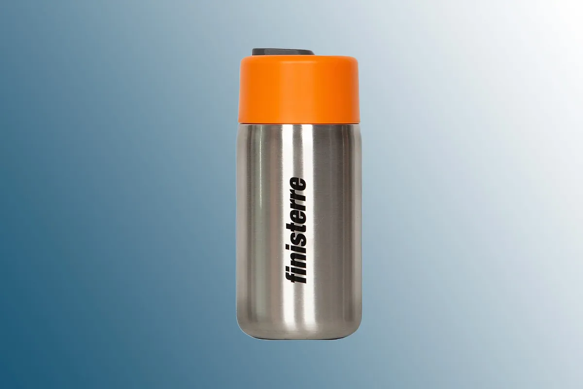 Finisterre Black Blum Steel Insulated Travel Cup on a blue background