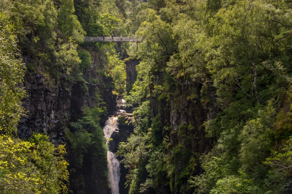 Falls of Measach crashing through Corrieshalloch Gorge beneath a suspension bridge