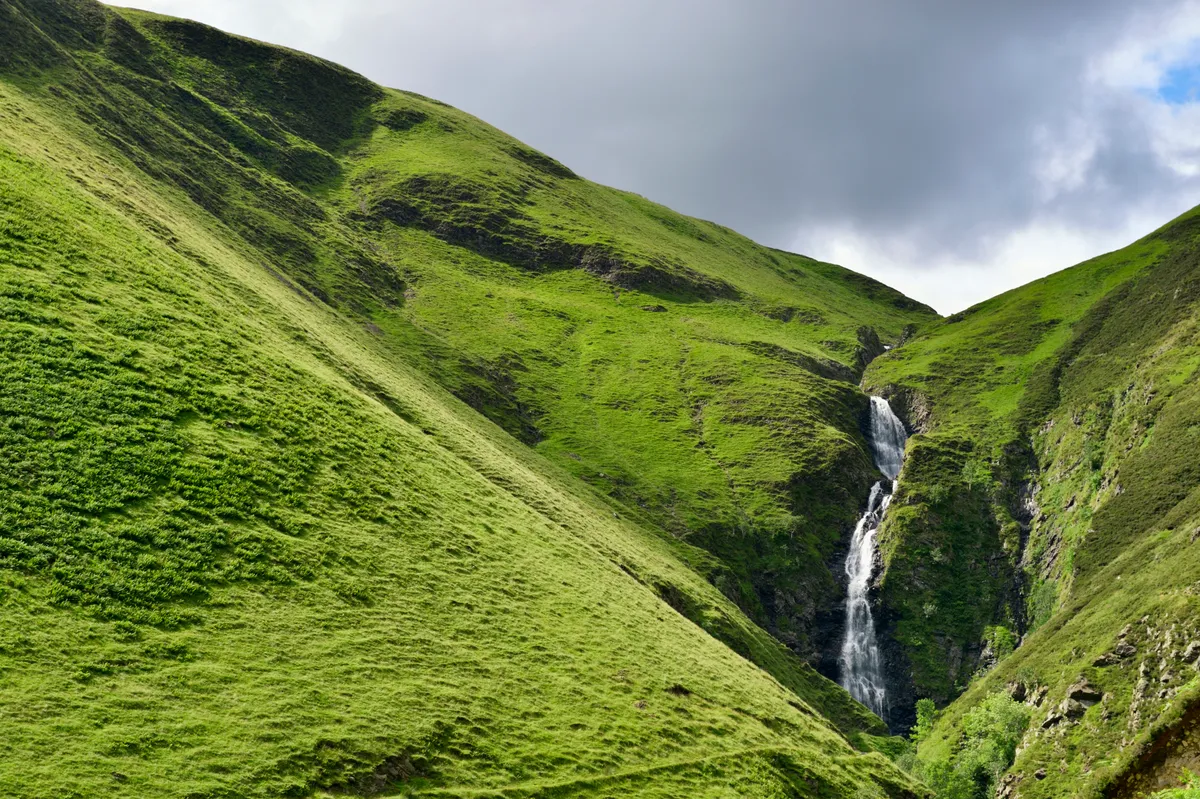 Grey Mares Tail waterfall in the hills of a rural part of Scotland