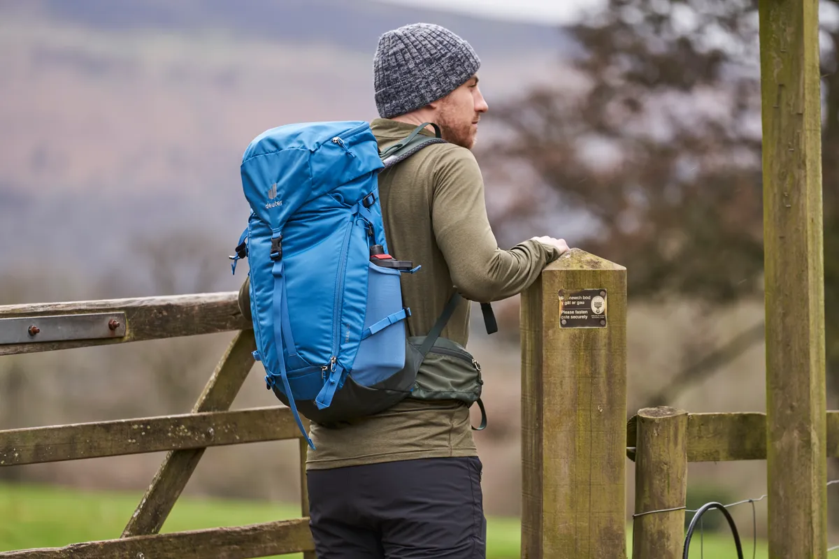 Man wearing Deuter Trail 30 backpack in the countryside