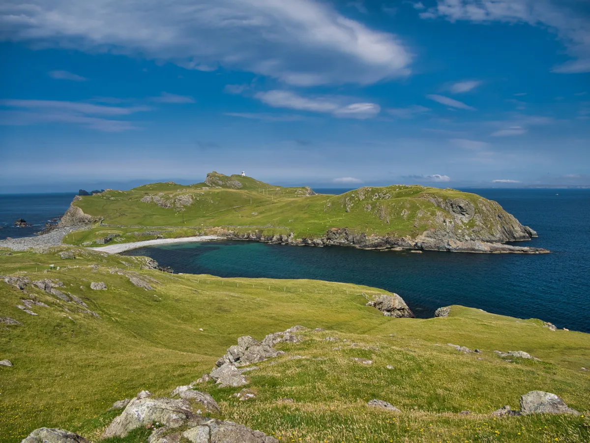 Landscape view of the beach and Isle Fethaland across the Wick of Breibister in the north of Mainland Shetland