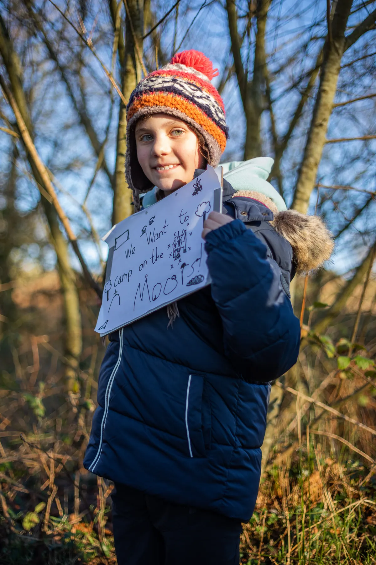 A child holds a placard at the Right to Roam protest.