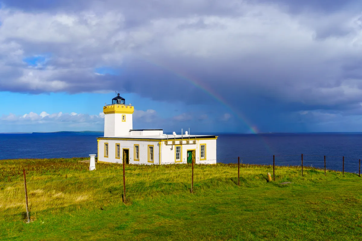 Duncansby Head Lighthouse with a rainbow