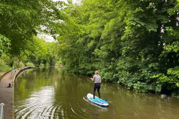 Maria Hodson paddleboarding on the Thames river at Cliveden in Berkshire