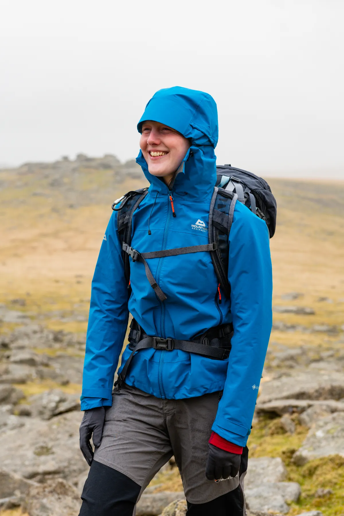 Female hiker in blue waterproof jacket