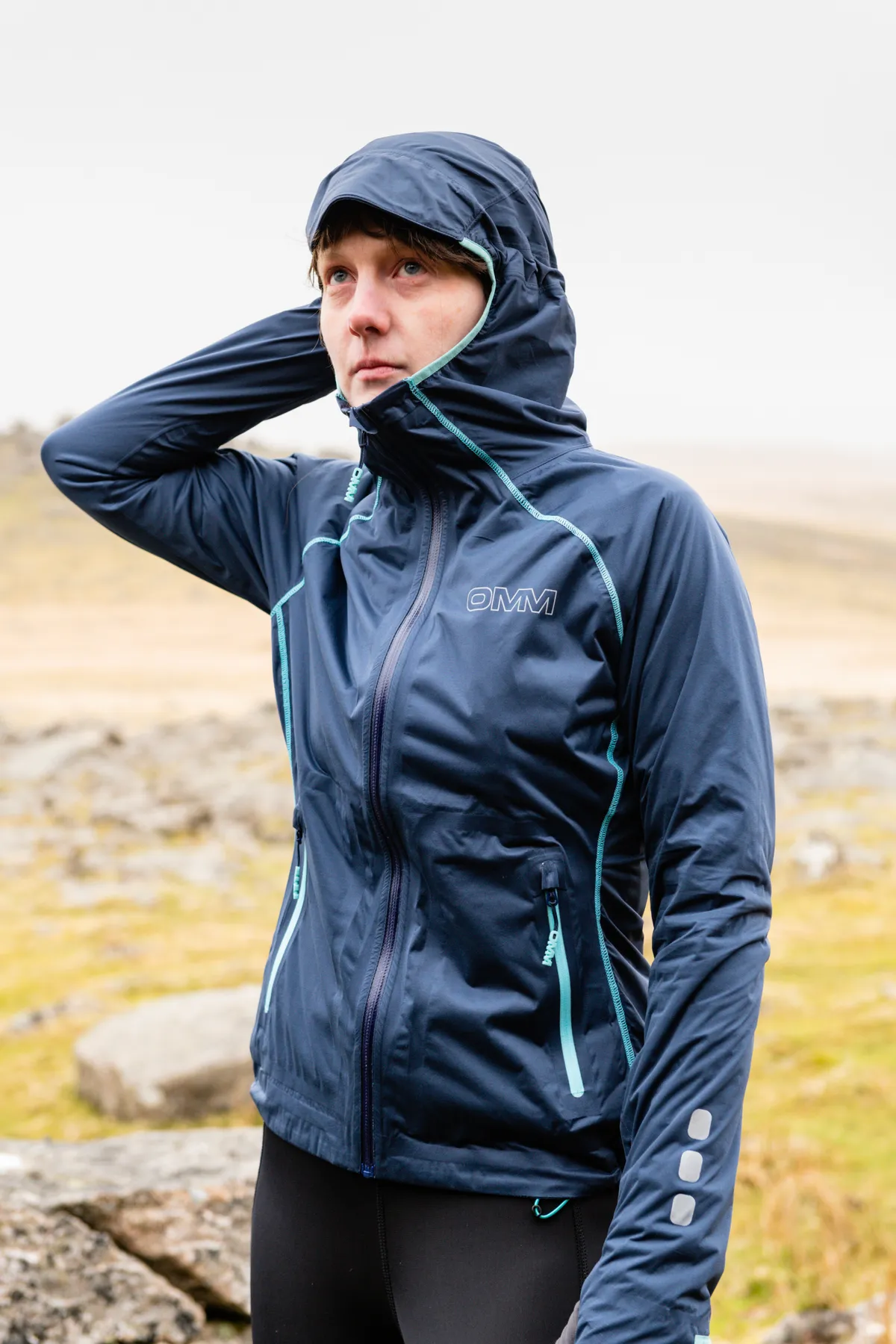 Trail runner in blue waterproof jacket