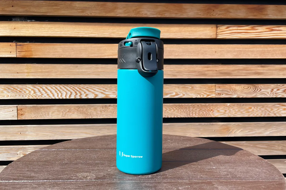 Super Sparrow Travel Mug on a wooden table