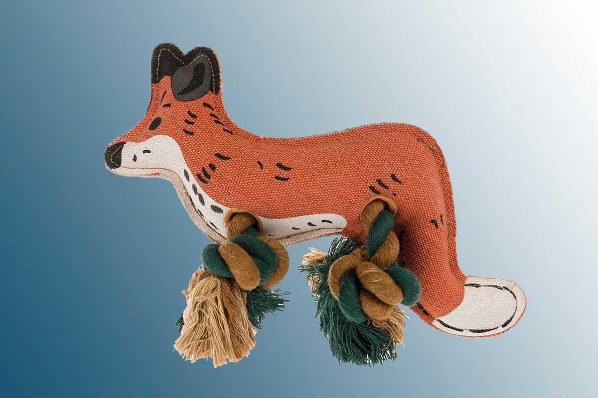 Sophie Allport Fox Dog Toy on a blue background