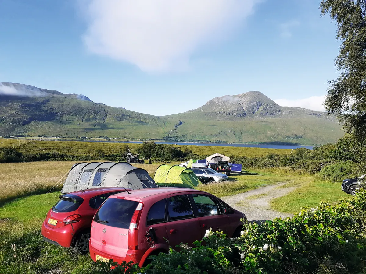 Tents and cars at Badrallach campsite by Little Loch Broom in Scotland