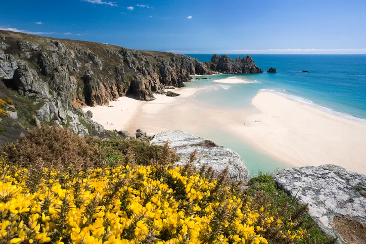 Porthcurno white sand beach looking towards Logans Rock in Cornwall England