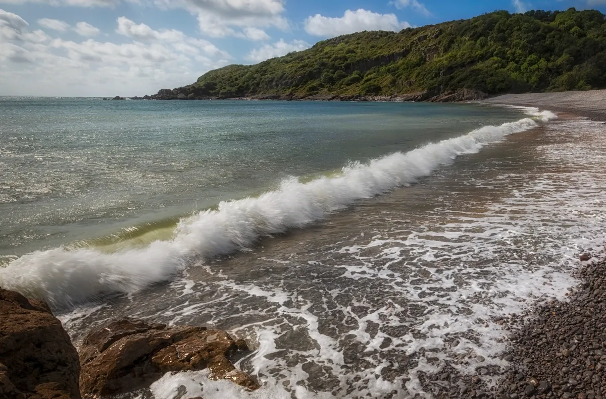Pwll Du Bay beach in summer with sea and blue sky