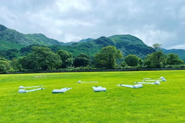Yoga mats on grass in front of Lake District mountains