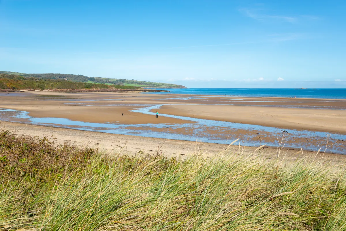 A sunny day at low tide on this beautiful beach on the east coast of Anglesey, north Wales.