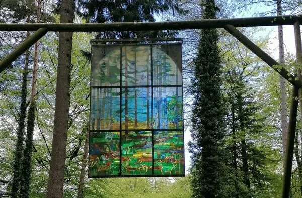 Stained glass window hanging in a forest