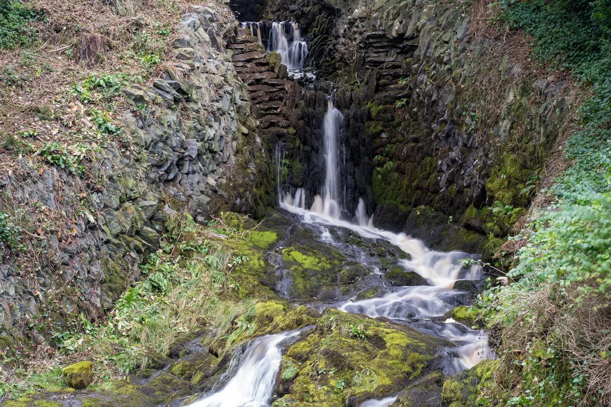 A scenic view of a small waterfall in Clapham village, Yorkshire dales, England