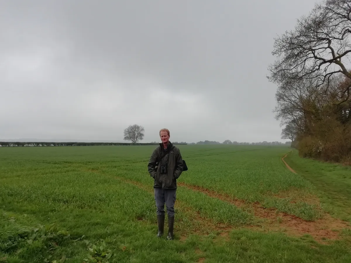 Author James MacDonald Lockhart walks along the edge of a field of barley listening to skylark songs