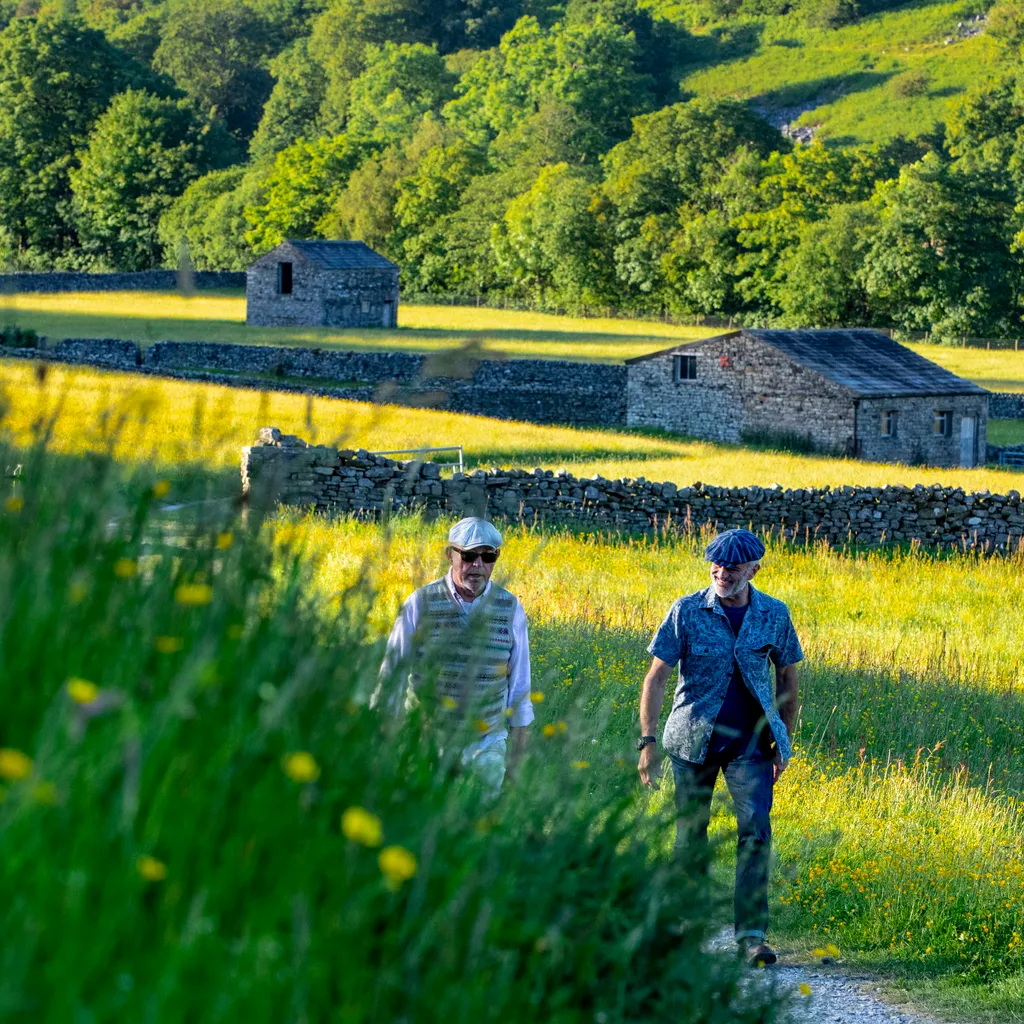 Walkers on the Pennine Way at Muker in the Yorkshire Dales