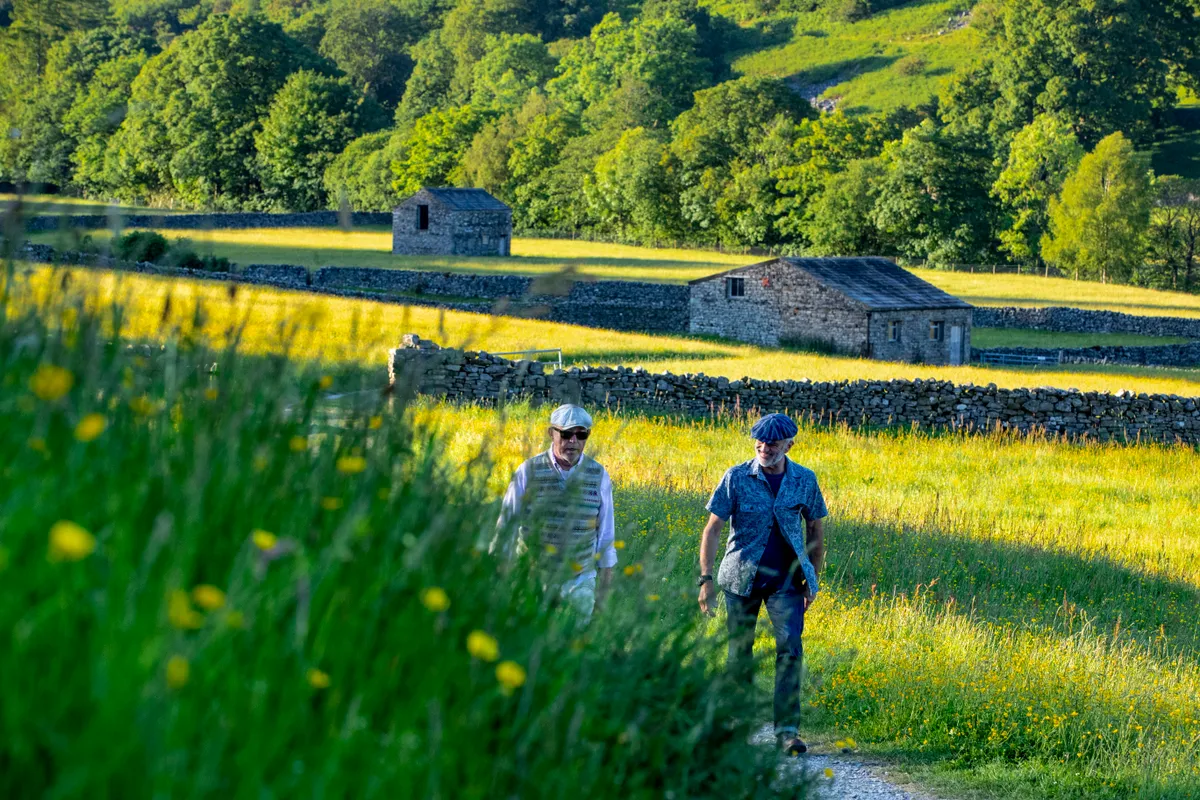 Walkers at Muker on the Pennine Way in summer
