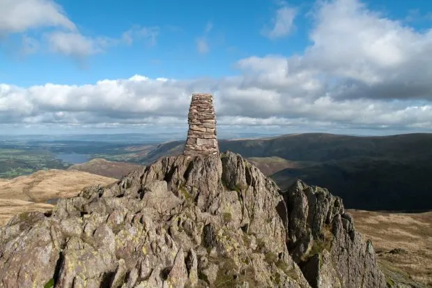 Summit of Place Fell in the Lake District with blue sky and clouds