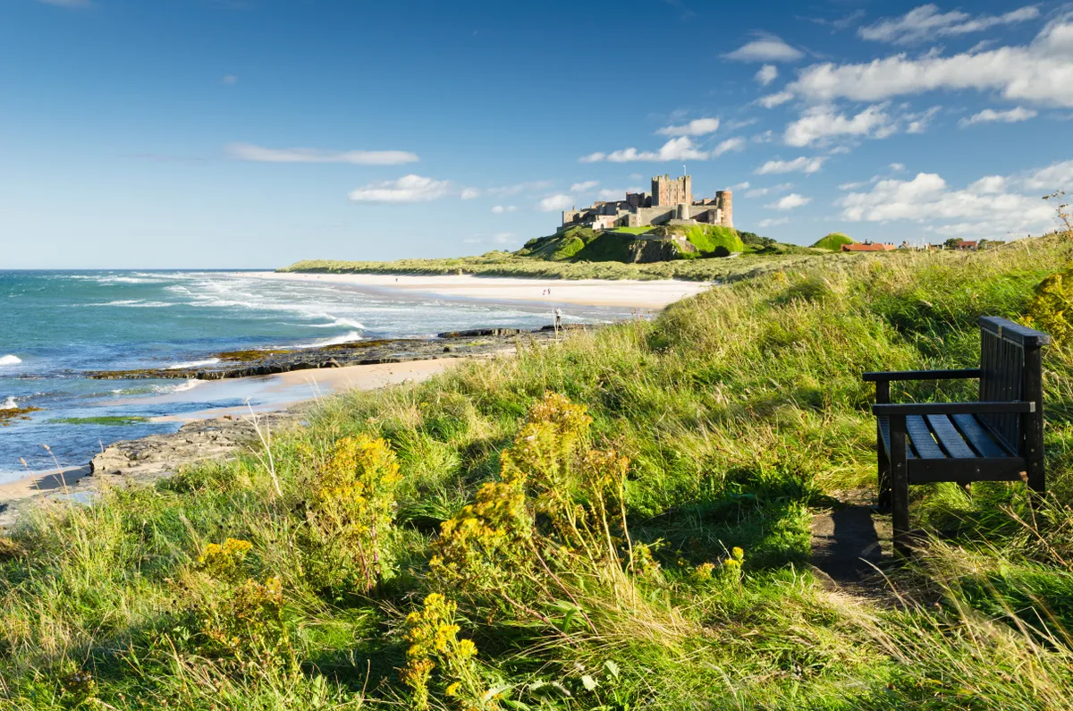 Bamburgh Castle and beach on a sunny day in summer