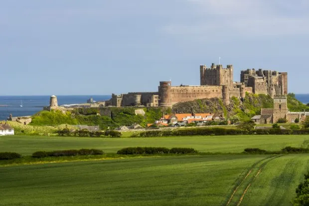 Bamburgh Castle and beach in Northumberland on a sunny day
