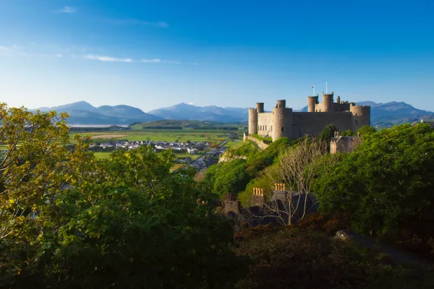 Harlech Castle with blue sky and mountains