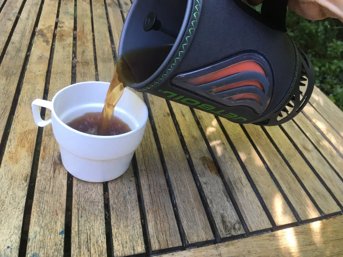 Pouring from the Jetboil Java Flash stove system on a wooden table