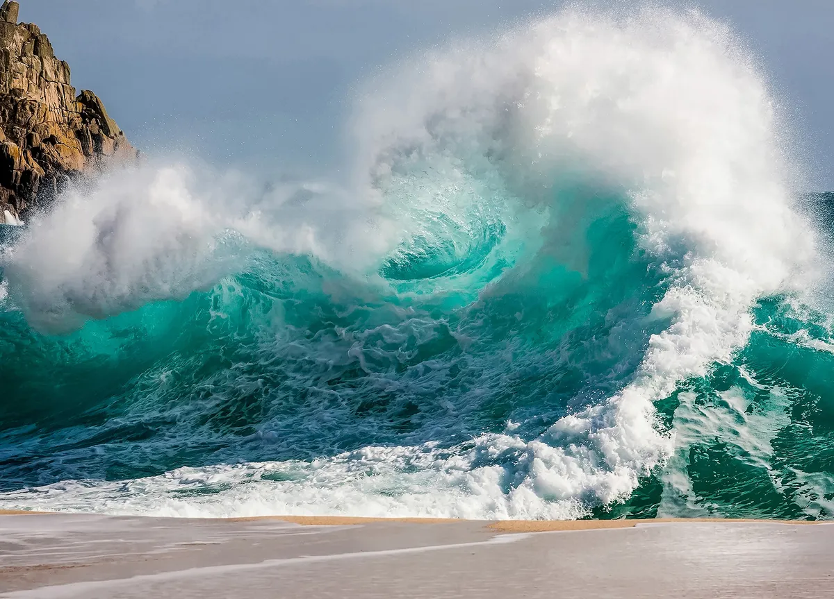A crashing wave hitting the shore