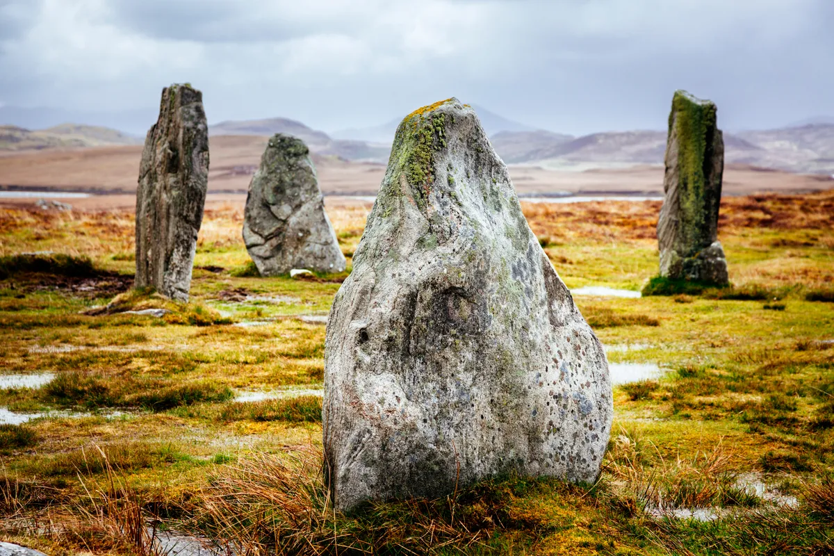 Callanish III Standing Stones on the Isle of Lewis with mountains behind
