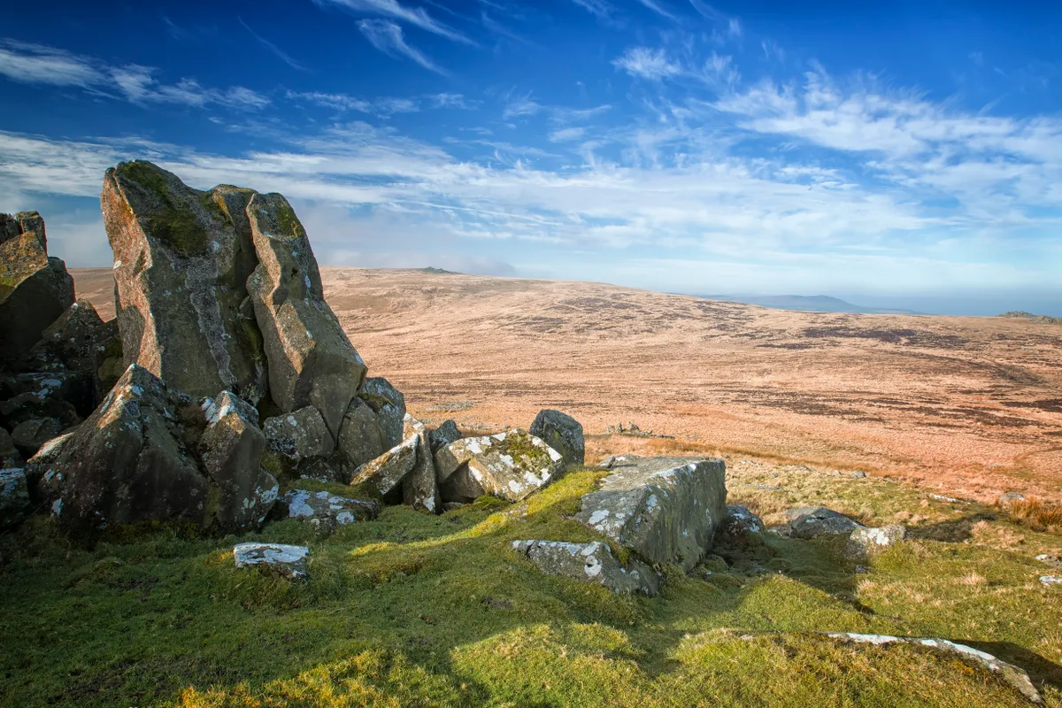 Carn Menyn bluestone outcrop with hills and blue sky