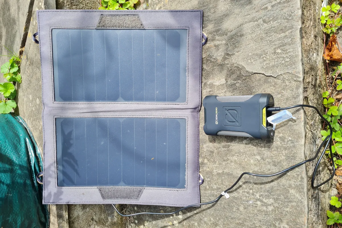 Goal Zero Venture 35 Power Bank and a solar panel against a patio