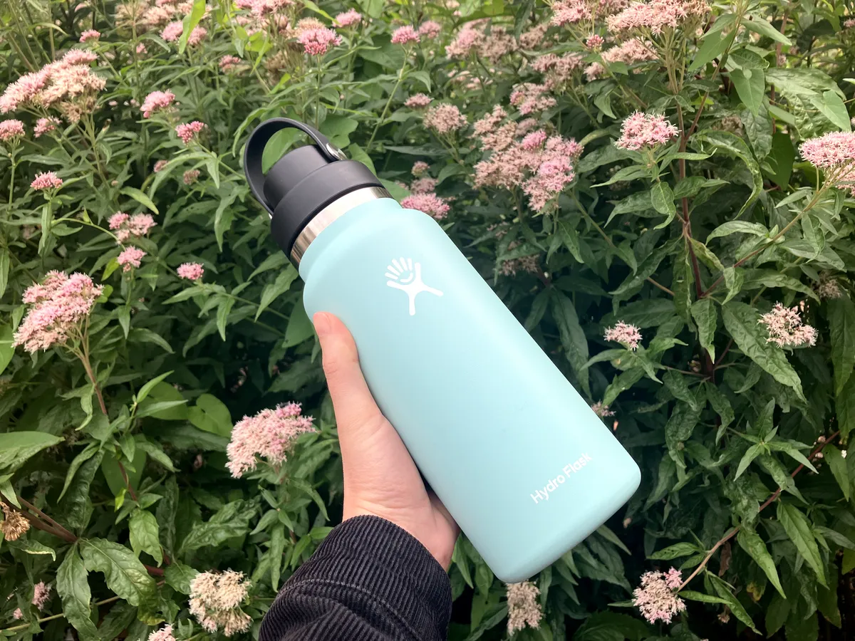 Blue bottle against flowers