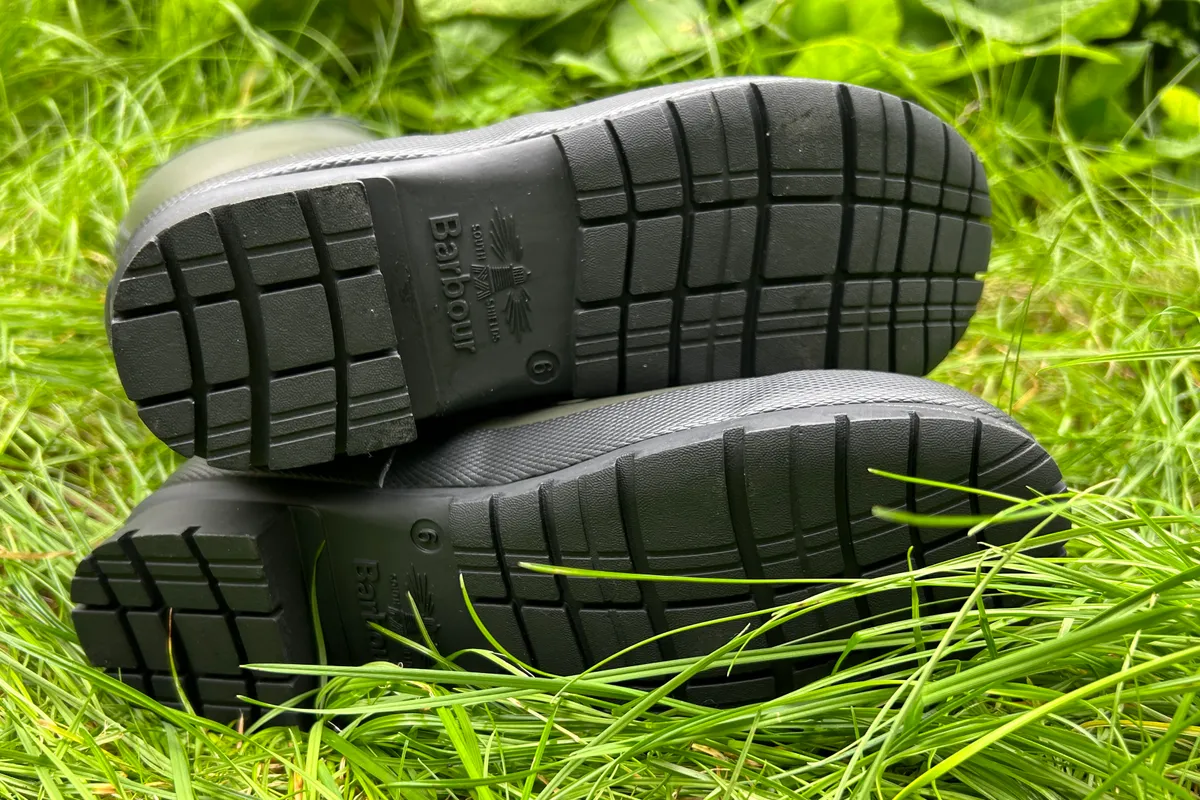 Soles of Barbour wellingtons on grass