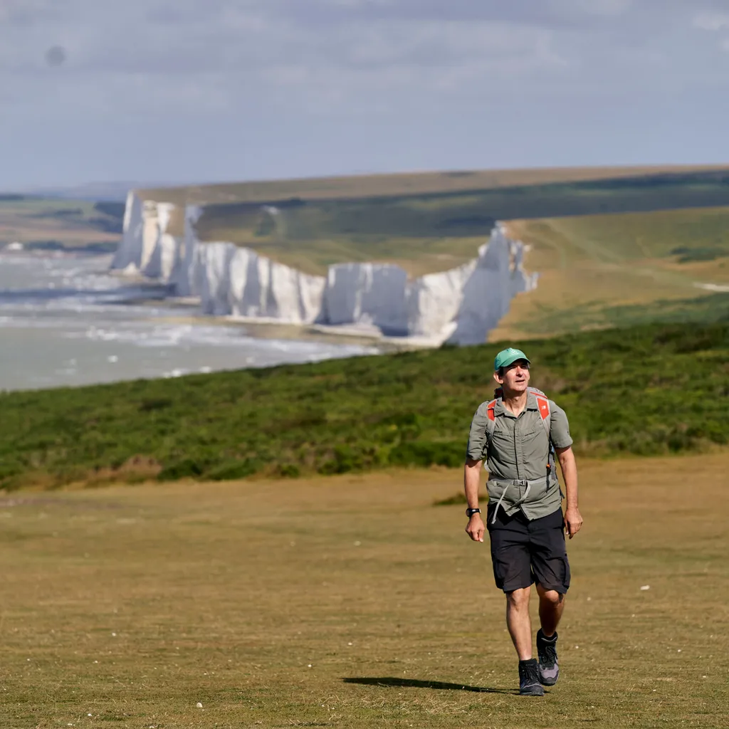 Walker cross the Seven Sisters cliffs on the South Downs Way