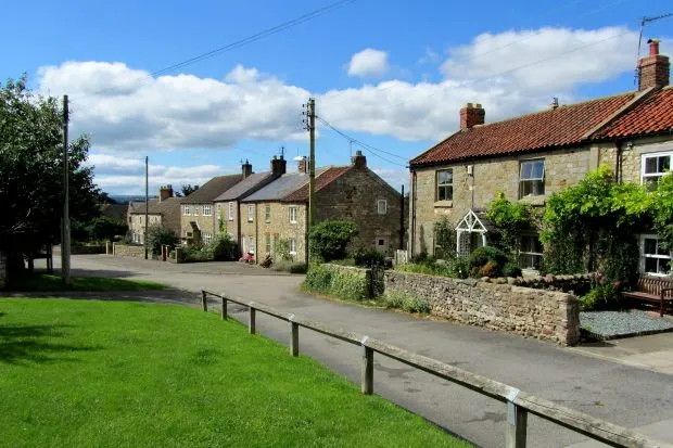 Thornborough village with houses and blue sky
